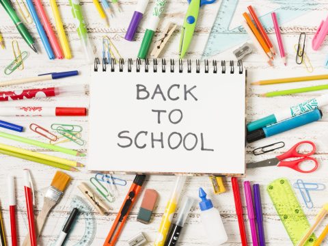 notepad-back-school-surrounded-by-school-supplies